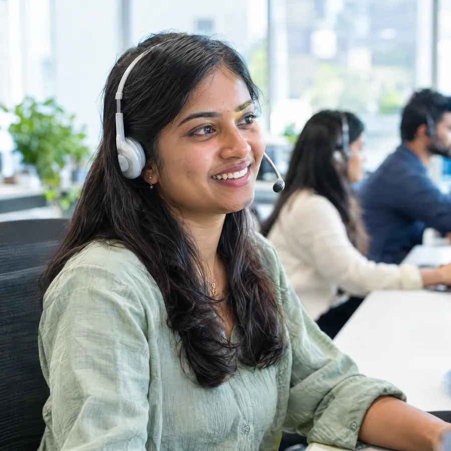 Support specialist smiling on a call