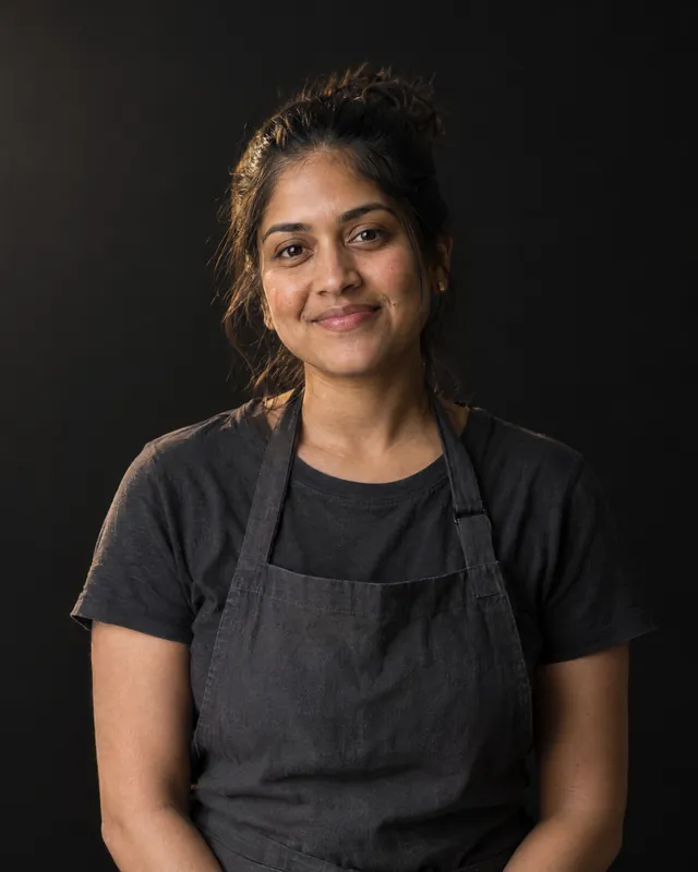 Cafe owner in an apron, smiling